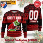 EPL SHEFFIELD UNITED THE GRINCH SANTA HAT WITH LOGO CUSTOM NAME NUMBER UGLY CHRISTMAS SWEATER EPL SHEFFIELD UNITED THE GRINCH SANTA HAT WITH LOGO CUSTOM NAME NUMBER UGLY CHRISTMAS SWEATER