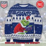 NFL NEW YORK GIANTS THE GRINCH SANTA HAT LOGO IN THE BALL UGLY CHRISTMAS SWEATER NFL NEW YORK GIANTS THE GRINCH SANTA HAT LOGO IN THE BALL UGLY CHRISTMAS SWEATER