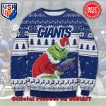 NFL NEW YORK GIANTS THE GRINCH SANTA HAT LOGO IN THE BALL UGLY CHRISTMAS SWEATER NFL NEW YORK GIANTS THE GRINCH SANTA HAT LOGO IN THE BALL UGLY CHRISTMAS SWEATER